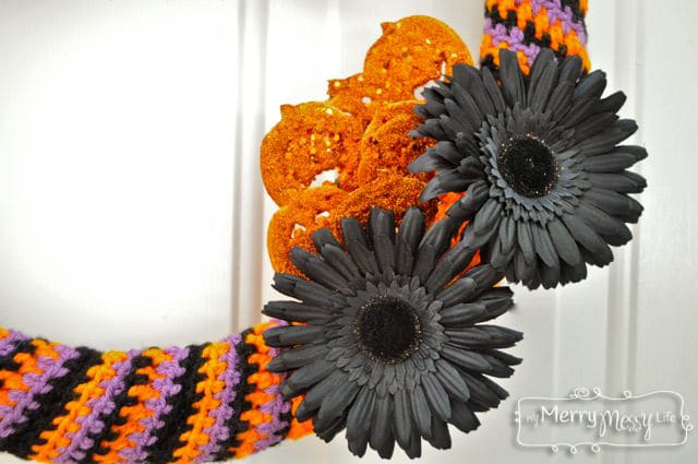 Attach the flowers and pumpkins to the wreath