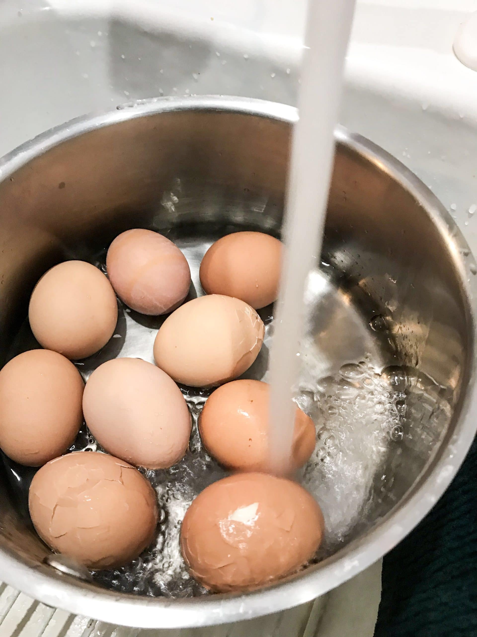 Run cold water over the eggs to stop the cooking process